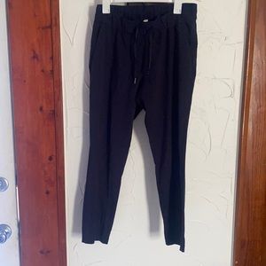 Lululemon size 8 navy On the Fly pants. 28”. Stretchy. NWOT.